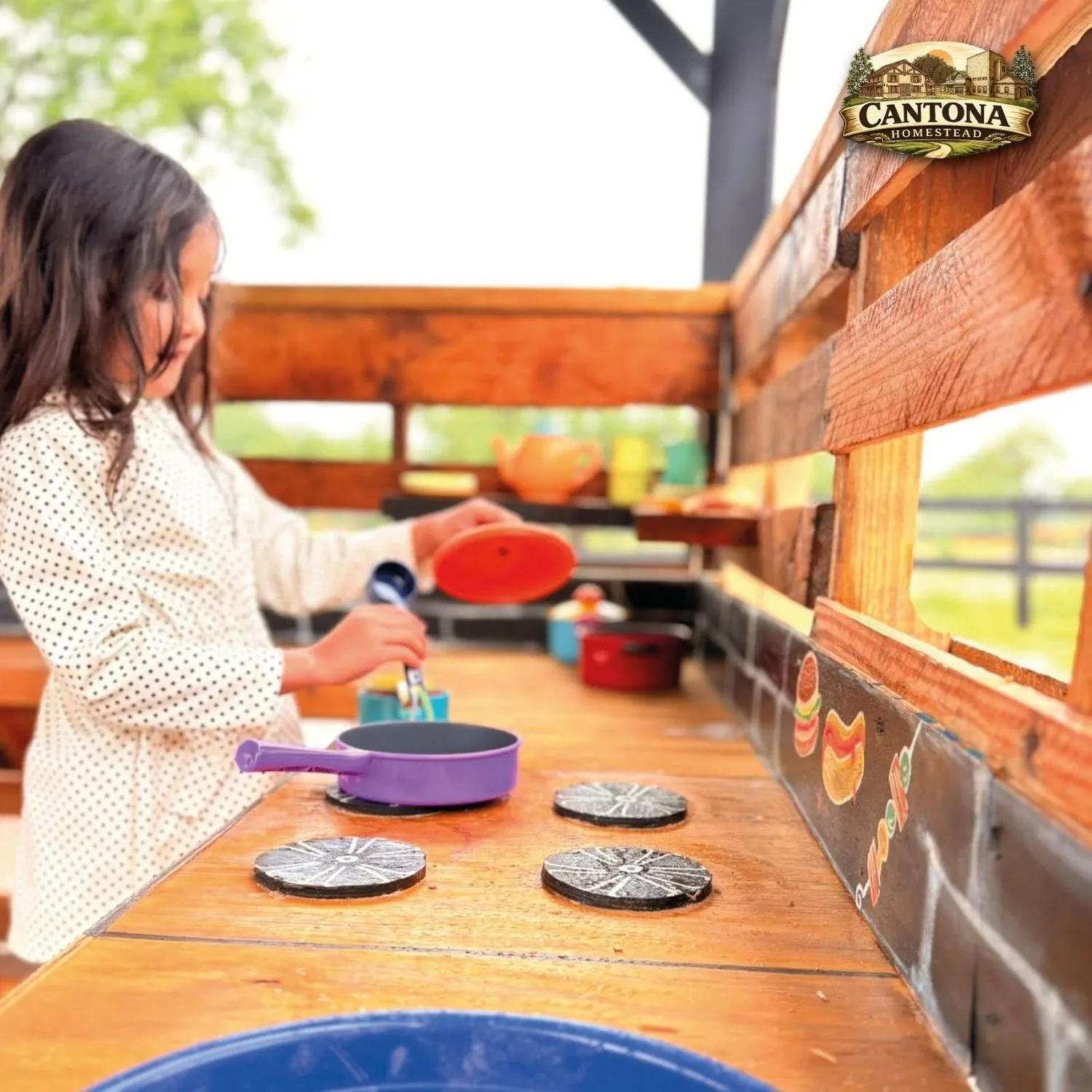 A child plays in the mud kitchen